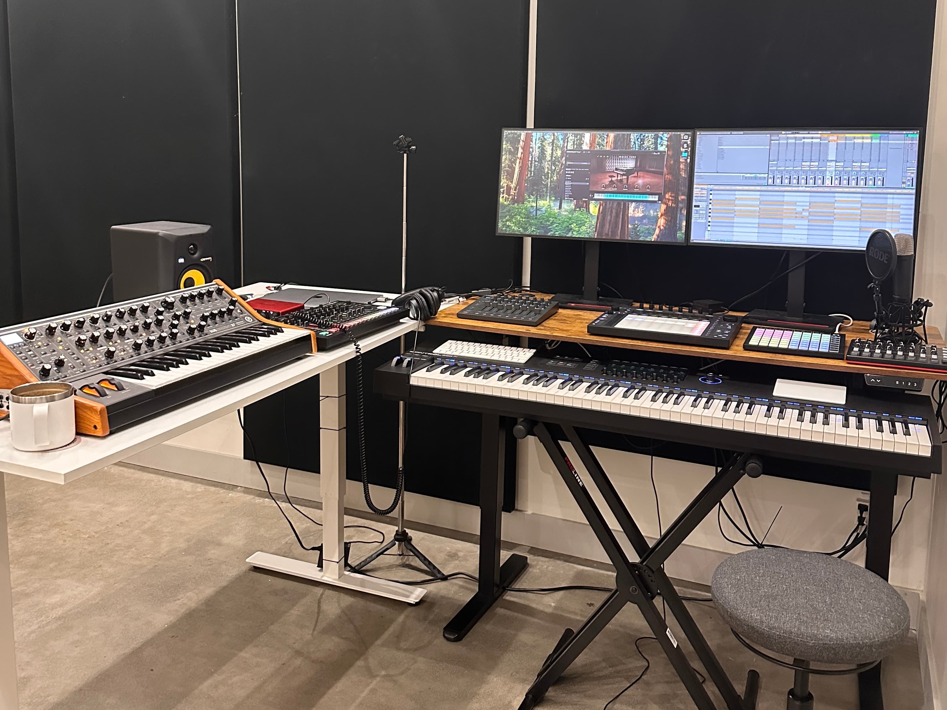 Studio setup with hardware synths, drum machines, and a focused mix position.